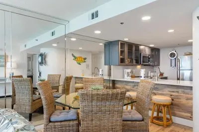 a kitchen and dining room with a table and chairs at One Seagrove Place 1706 in Santa Rosa Beach
