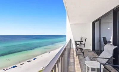 a balcony with chairs and a view of the beach at One Seagrove Place 1201 in Santa Rosa Beach