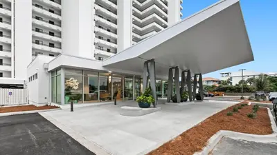 a building with a large white building at One Seagrove Place 0207 in Santa Rosa Beach