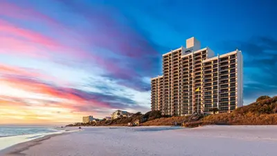 a tall building on the beach next to the ocean at One Seagrove Place 0207 in Santa Rosa Beach