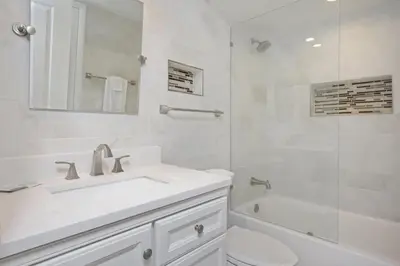 a white bathroom with a sink and a shower at One Seagrove Place 1204 in Santa Rosa Beach