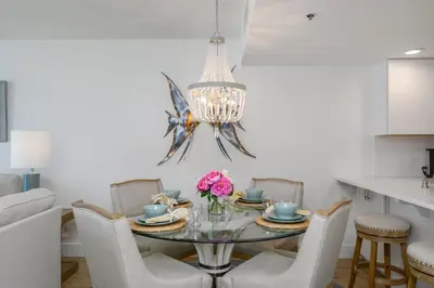 a dining room with a glass table and chairs at One Seagrove Place 1204 in Santa Rosa Beach