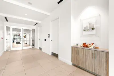 a hallway with white walls and a counter with stuffed animals at One Seagrove Place 0208 in Santa Rosa Beach