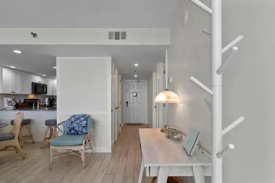 a kitchen and living room with a table and chairs at One Seagrove Place 0208 in Santa Rosa Beach