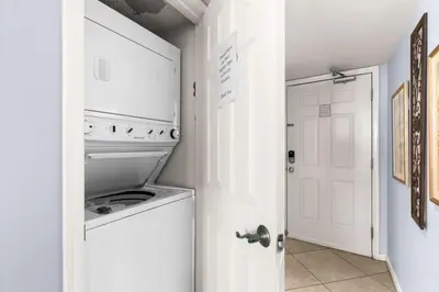 a white laundry room with a washer and dryer at One Seagrove Place 1505 in Santa Rosa Beach