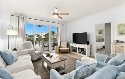 a living room with white furniture and a tv at High Pointe Resort 232 in Santa Rosa Beach