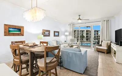 a dining room and living room with a table and chairs at High Pointe Resort 232 in Santa Rosa Beach
