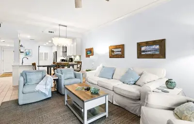 a living room with a white couch and blue chairs at High Pointe Resort 232 in Santa Rosa Beach