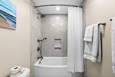 a white bathroom with a tub and a shower at High Pointe Resort 232 in Santa Rosa Beach