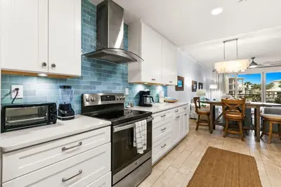 a kitchen with white cabinets and a stove top oven at High Pointe Resort 232 in Santa Rosa Beach