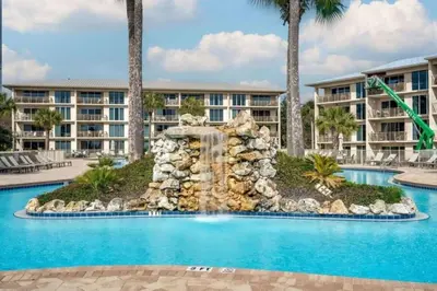 a swimming pool with a waterfall in front of a resort at High Pointe Resort 232 in Santa Rosa Beach