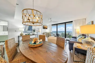 a living room with a wooden table and chairs at One Seagrove Place 0305 in Santa Rosa Beach