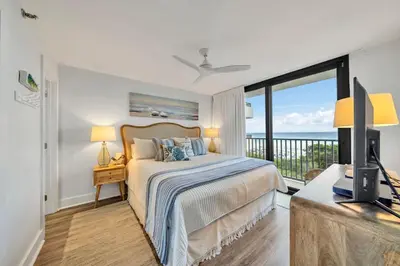 a bedroom with a bed with a view of the ocean at One Seagrove Place 0305 in Santa Rosa Beach