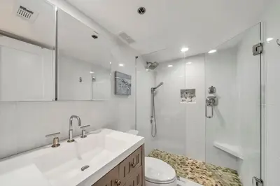 a bathroom with a shower and a sink and a toilet at One Seagrove Place 0305 in Santa Rosa Beach