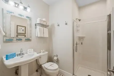 a bathroom with a toilet and a sink and a shower at SunDune on 30A in Santa Rosa Beach