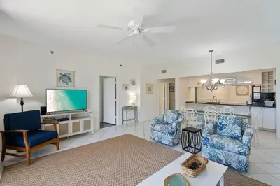 a living room with two chairs and a tv at High Pointe Resort 131 in Inlet Beach
