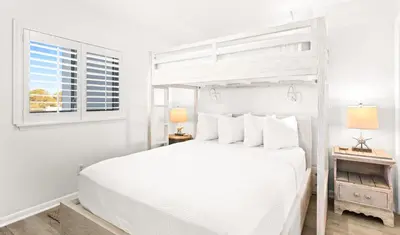 a white bedroom with a white bed and a window at One Seagrove Place 0406 in Santa Rosa Beach