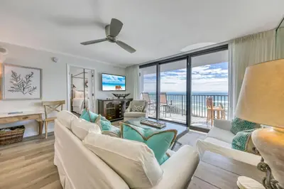 a living room with a white couch and a view of the ocean at One Seagrove Place 0406 in Santa Rosa Beach