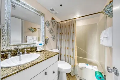 a bathroom with a sink and a shower and a toilet at One Seagrove Place 1703 in Santa Rosa Beach