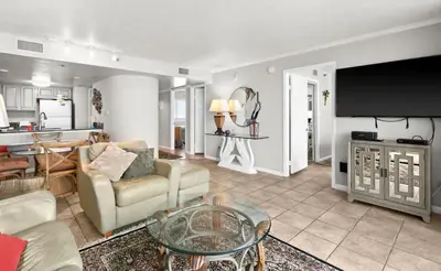 a living room with a couch and a table at One Seagrove Place 1806 in Santa Rosa Beach