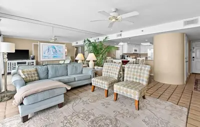 a living room with a blue couch and chairs at One Seagrove Place 2106 in Santa Rosa Beach