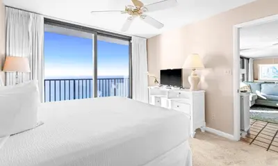 a bedroom with a white bed and a large window at One Seagrove Place 2106 in Santa Rosa Beach