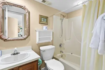 a bathroom with a sink and a toilet and a shower at One Seagrove Place 2106 in Santa Rosa Beach