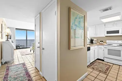 a kitchen with white cabinets and a view of the ocean at One Seagrove Place 2106 in Santa Rosa Beach