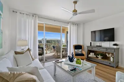 a living room with a white couch and a tv at High Pointe Resort 432 in Inlet Beach