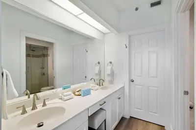 a white bathroom with a sink and a mirror at High Pointe Resort 432 in Inlet Beach