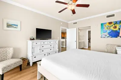 a bedroom with a white bed and a ceiling fan at Palazzo 0507 in Panama City Beach