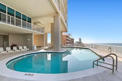 a swimming pool with a view of the ocean at Palazzo 0507 in Panama City Beach