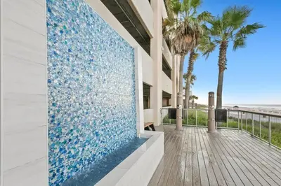 a building with a mosaic wall with palm trees at Palazzo 0507 in Panama City Beach
