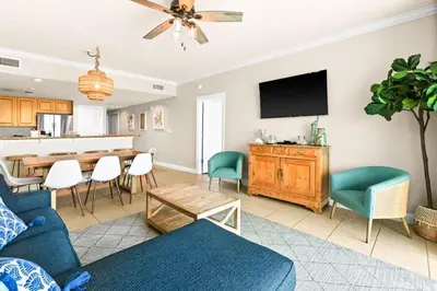 a living room with a blue couch and a table at Palazzo 0507 in Panama City Beach