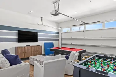 a living room with a pool table and a tv at Laguna Loafin' in Panama City Beach