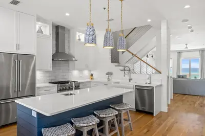 a kitchen with a large kitchen island with bar stools at Laguna Loafin' in Panama City Beach