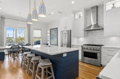 a kitchen with a large blue island in a kitchen at Laguna Loafin' in Panama City Beach