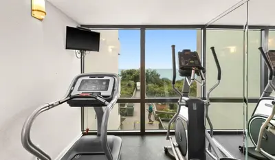 a gym with two exercise bikes and a window at One Seagrove Place 0408 in Santa Rosa Beach