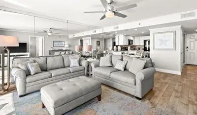 a living room with two couches and a couch and a table at One Seagrove Place 0408 in Santa Rosa Beach