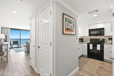 a kitchen with a door leading to a living room at One Seagrove Place 0408 in Santa Rosa Beach