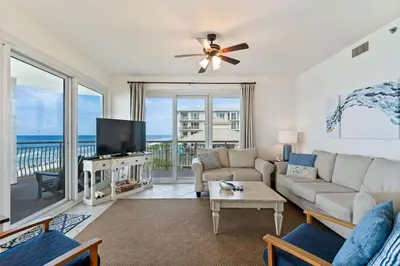 a living room with a couch and a tv at High Pointe Resort E26 in Inlet Beach
