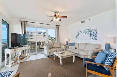 a living room with a couch and a tv at High Pointe Resort E26 in Inlet Beach