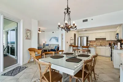 a kitchen and dining room with a table and chairs at High Pointe Resort E26 in Inlet Beach