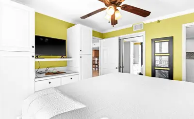 a bedroom with a white bed and a ceiling fan at One Seagrove Place 1606 in Santa Rosa Beach