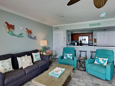 a living room with a couch and two chairs at Emerald Beach #1333 in Panama City Beach