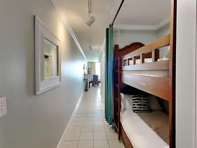 a hallway with bunk beds in a room at Emerald Beach #1333 in Panama City Beach