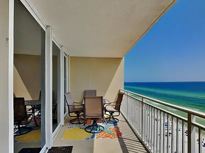 a balcony with chairs and a view of the ocean at Emerald Beach #1333 in Panama City Beach