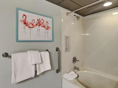 a bathroom with a shower and a bath tub with towels at Emerald Beach #1333 in Panama City Beach
