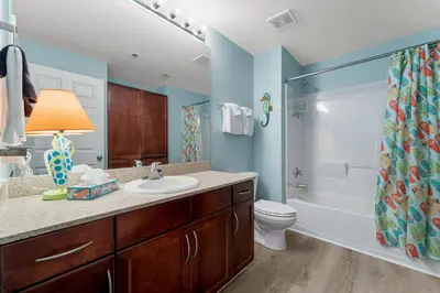 a bathroom with a sink and a toilet and a shower at Laketown Wharf #1433 in Panama City Beach