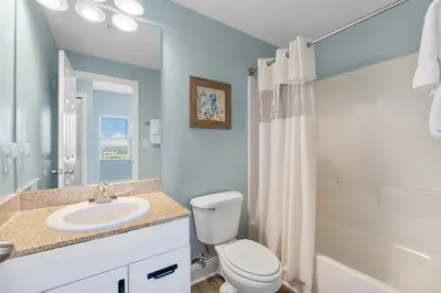 a bathroom with a white toilet and a sink at Laketown Wharf #1510 in Panama City Beach
